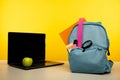 School backpack with supplies and laptop on a table Royalty Free Stock Photo