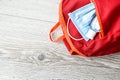 School bag, medical mask and sanitizer antiseptic on wooden table. Back to school concept. School quarantine concept. Copy space Royalty Free Stock Photo