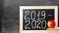 School board with text 2019 2020. Background School blackboard, apple and book