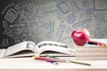 School books and apple against blackboard Royalty Free Stock Photo
