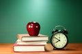 School Books, Apple and Clock on Desk at School Royalty Free Stock Photo