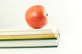 School books with apple in white background Royalty Free Stock Photo