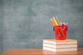 School books on desk, Back to school supplies. Books and blackboard on wooden background, education concept Royalty Free Stock Photo