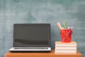 School books on desk, Back to school supplies. Books and blackboard on wooden background, education concept Royalty Free Stock Photo