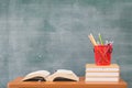 School books on desk, Back to school supplies. Books and blackboard on wooden background, education concept Royalty Free Stock Photo