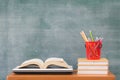 School books on desk, Back to school supplies. Books and blackboard on wooden background, education concept Royalty Free Stock Photo