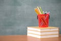 School books on desk, Back to school supplies. Books and blackboard on wooden background, education concept Royalty Free Stock Photo