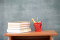 School books on desk, Back to school supplies. Books and blackboard on wooden background, education concept Royalty Free Stock Photo