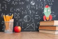 School books on desk infront of blackboard with formulas. education concept Royalty Free Stock Photo