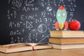 School books on desk infront of blackboard with formulas. education concept Royalty Free Stock Photo