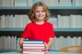 School books and education concept. Little student boy reading book at school. Kid doing homework, sitting at table by Royalty Free Stock Photo