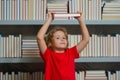 School books and education concept. Schoolboy reading book in library. Kids learn to read. Pupil reading books in a Royalty Free Stock Photo