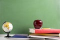 School Books a red Apple and a Globe