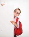 School boy with backpack above blank empty billboard sign  on white background. Kid portrait in glasses hiding Royalty Free Stock Photo