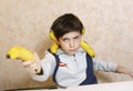 School boy with banana performing ninjia Royalty Free Stock Photo
