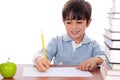 School boy doing his homework with an apple Royalty Free Stock Photo