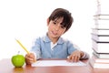 School boy doing his homework with an apple Royalty Free Stock Photo