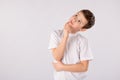 School boy looking up thinking looking for clues or idea isolated on a white Royalty Free Stock Photo