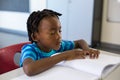 School boy memorizing the lesson in classroom