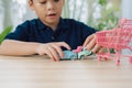 School boy playing with toy car on a table at home Royalty Free Stock Photo