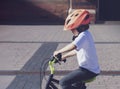 School boy riding bike in a helmet, Cropped shot kid learns to ride bicycle in the Park, Candid photo Child in helmet riding a Royalty Free Stock Photo