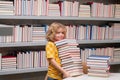 School boy. Schoolboy reading book in library. Kids learn to read. Pupil reading books in a school library. School child Royalty Free Stock Photo