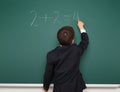School boy solve math on school board Royalty Free Stock Photo