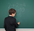 School boy solve math on school board Royalty Free Stock Photo