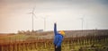 School boy stand on the wind farm. Wind turbines are alternative electricity sources. Future of kid and sustainable Royalty Free Stock Photo