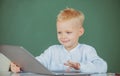 School boy studying math during online lesson in classroom, online education. Little funny programmer. Royalty Free Stock Photo