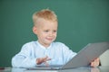 School boy studying math during online lesson in classroom, online education. Little funny programmer. Royalty Free Stock Photo