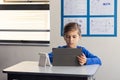 In school, boy using tablet for studying math in classroom Royalty Free Stock Photo