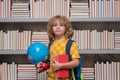 School boy with world globe and books. School child studying in classroom at elementary school. Kid studying on lesson Royalty Free Stock Photo