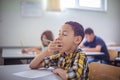 School boy yawing on class