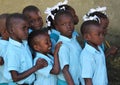 School boys and girls hurry queue up to class in Robillard, Haiti.