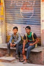 School boys sitting in the street in Taj Ganj neighborhood of Ag