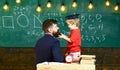 School break concept. Boy, child in graduate cap play with dad, having fun and relaxing during school break. Teacher