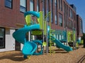 School building with playground equipment Royalty Free Stock Photo