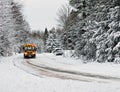 School Bus Driving Down A Snow Covered Rural Road - 1 Royalty Free Stock Photo