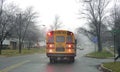 School bus picking up children on a foggy morning