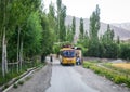 A school bus running on road in Ladakh, India Royalty Free Stock Photo