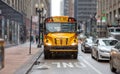 School Bus USA. Yellow Classic Public Bus On The Street, Only Bus Lane, American City Downtown