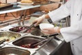 School canteen worker at serving line. Tasty food