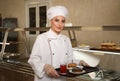 School canteen worker with food near serving line