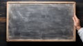 School chalkboard. Hand holding the board Royalty Free Stock Photo