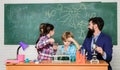 School chemistry experiment. Fascinating chemistry lesson. Man bearded teacher and pupils with test tubes in classroom Royalty Free Stock Photo