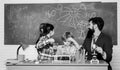 School chemistry experiment. Fascinating chemistry lesson. Man bearded teacher and pupils with test tubes in classroom Royalty Free Stock Photo