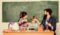 School chemistry experiment. Fascinating chemistry lesson. Man bearded teacher and pupils with test tubes in classroom Royalty Free Stock Photo