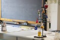 School chemistry laboratory. Various colored solutions with blackboard in the background