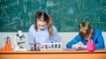 School chemistry lesson. School laboratory. Girl and boy smart students conduct school experiment. Describe chemical